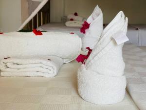 a group of towels sitting on top of a bed at Babalao Bungalows in Nungwi