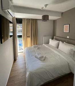 מיטה או מיטות בחדר ב-Niarchos apartment III