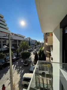 a view of a city street from a balcony of a building at Niarchos apartment III in Athens