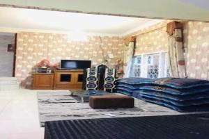 a bedroom with a bed and a tv in it at EXPRESS O 91923 Homestay Zona in Sukabumi