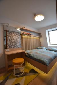 a bedroom with a bed and a desk and a stool at Splendid View Place in Jahorina