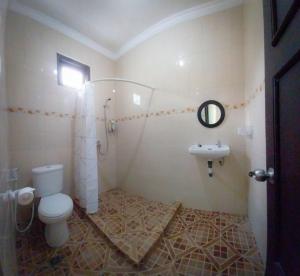 a bathroom with a toilet and a sink at Gated 3BR Residence - 10 mins from Malioboro in Yogyakarta