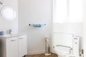 a white bathroom with a toilet and a sink at Studio cosy Pinot Meunier au cœur d'Hautvillers in Hautvillers