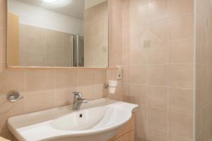 a bathroom with a sink and a mirror at Huterhof Apt Talblick in Riobianco +15 photos
