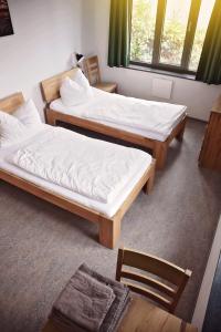 Postel nebo postele na pokoji v ubytování Hotel Garni Fischerfleck in Ismaning near Munich
