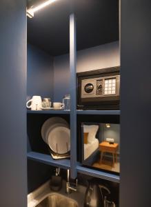 a kitchen with a sink and a microwave at K23 Color Suites in Athens