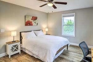 a bedroom with a bed and a ceiling fan at Contemporary Home 8 Mi to Downtown Asheville! in Asheville
