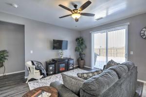 a living room with a couch and a ceiling fan at Bellemont Home about 12 Mi to Flagstaff! in Bellemont