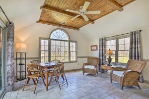 a dining room with a table and chairs and windows at Chateau Ridge Peaceful Retreat with Fire Pit! in Westminster