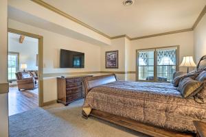 a bedroom with a bed and a television and a chair at Chateau Ridge Peaceful Retreat with Fire Pit! in Westminster