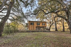 a wooden cabin in the middle of a park with trees at Renovated Fort White Retreat with River Access! in Fort White