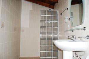 a bathroom with a sink and a mirror at Doga Apartments in Kayakoy