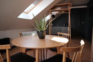 a wooden table with a potted plant on top of it at Vanadziņa māja in Cēsis