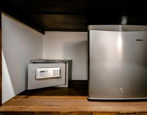 a microwave oven sitting in a kitchen next to a wall at Saltasia Boutique Beach Villa in Mirissa