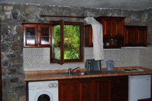 a kitchen with a sink and a window at Doga Apartments in Kayakoy