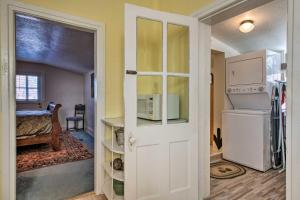 a kitchen with a door open to a room with a refrigerator at Kik-N-Bak Cottage with Beautiful Mountain View in Manti +18 photos