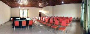 a room with red chairs and a table in it at MOUCECORE in Kigali