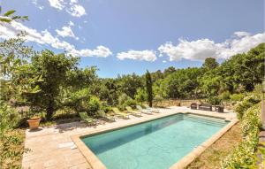 a swimming pool with lounge chairs in a yard at 3 Bedroom Stunning Home In Montauroux in Montauroux