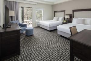 a hotel room with two beds and a television at Toll House Hotel Los Gatos in Los Gatos