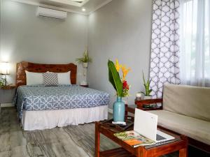 Cama ou camas em um quarto em Palm View Moalboal