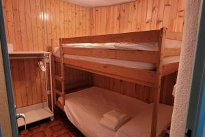 two bunk beds in a room with wooden walls at Casa Gracia in Sacedón