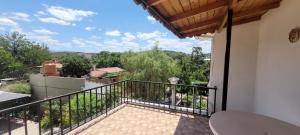 a balcony with a view of the mountains at HERMINIA in Villa Carlos Paz