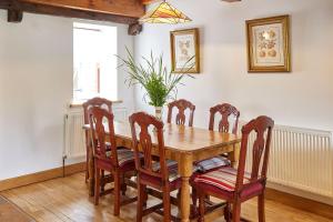 a dining room with a wooden table and chairs at Host & Stay - The Cottage Barn in Skipton