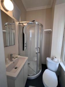 a bathroom with a shower and a toilet and a sink at Suites & Apartments DP VFXira in Vila Franca de Xira