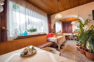 a restaurant with tables and a window and a table at Garni Bondi in Selva di Val Gardena