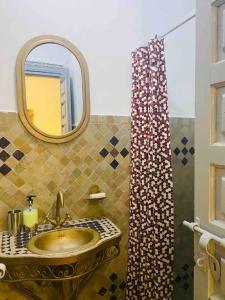 ein Badezimmer mit Waschbecken und Spiegel in der Unterkunft Jolie petit Riyad avec piscine belle terrasse wifi in Marrakesch