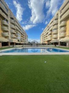 a large swimming pool in the middle of a building at 2 rooms con piscina litoral in Málaga