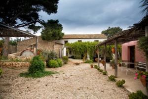 a house with a yard with a stone building at Mas Masdeu in L'Aldea