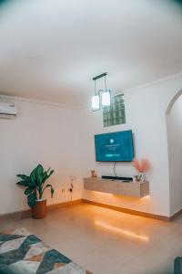 a living room with a flat screen tv on a wall at Two bedroom Apartment in Oyster Bay in Dar es Salaam
