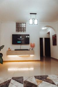 a living room with a flat screen tv on a wall at Two bedroom Apartment in Oyster Bay in Dar es Salaam