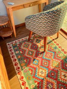 a chair sitting on a rug next to a table at Nebo Apartments Paje in Paje