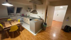 cocina y comedor con mesa y sillas amarillas en Großzügige Maisonette Wohnung über den Dächern Leipzigs, en Leipzig