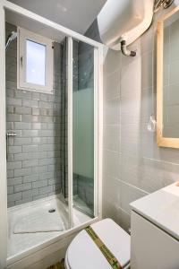 a bathroom with a shower and a toilet and a sink at Charming Retiro II in Madrid