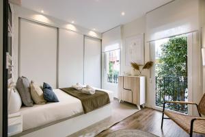 a bedroom with a bed and a large window at Charming Retiro II in Madrid