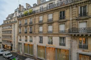 a large building with windows and balconies on a street at The place to be in Saint Germain des Près - Montana 2 in Paris