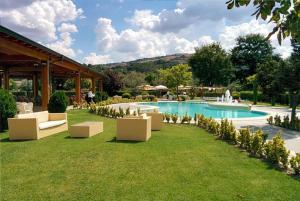a resort with a swimming pool and chairs in the grass at Hotel Villa d'Evoli in Castropignano