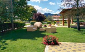 a garden with couches and flowers in the grass at Hotel Villa d'Evoli in Castropignano