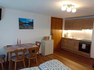 a kitchen and dining room with a table and chairs at Burgerhof in Pettneu am Arlberg