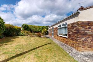 a brick house with a yard in front of it at Alberts Retreat in Abergele