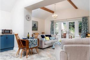 a living room with a couch and a table at Beudy Bach in Llanrwst