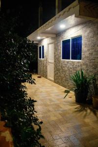 a brick house with a patio at night at Posada Miss Gloría in San Andrés