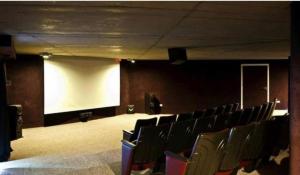 an empty auditorium with a white screen and chairs at Linda Bay Beach & Resort Studio 304 in Mar de las Pampas +7 photos