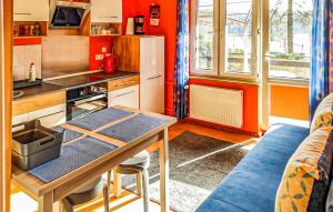 a small kitchen with a table and a couch at Awesome Apartment In Stawiguda With Kitchen in Stawiguda