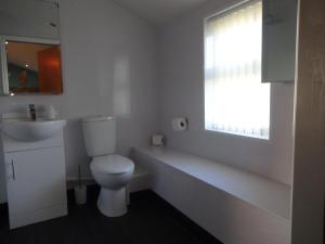 a bathroom with a toilet and a sink and a window at John Collingwood, Bowness-on-Solway in Bowness-on-Solway