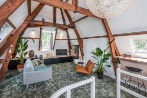 an attic living room with wooden beams at Hotel Arena in Amsterdam