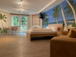 a bedroom with two beds and palm trees on the wall at Villa Am Park in Bad Homburg vor der Höhe